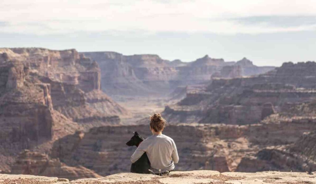 woman meditating with a dog