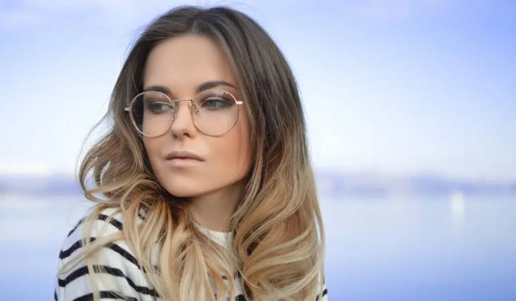 gemini sun leo moon woman wearing glasses