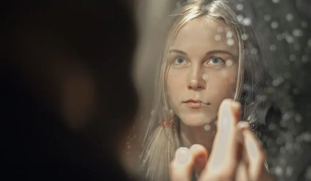 gemini sun scorpio moon woman looking in the mirror