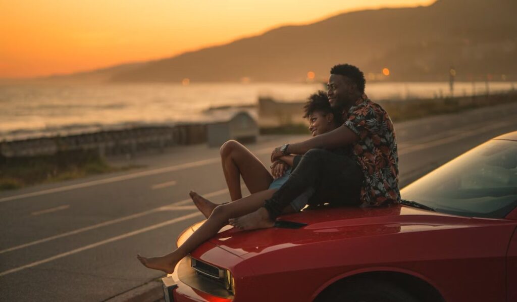 mercury trine pluto couple sitting on a car