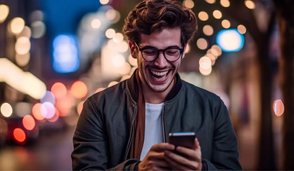 man smiling looking at his phone