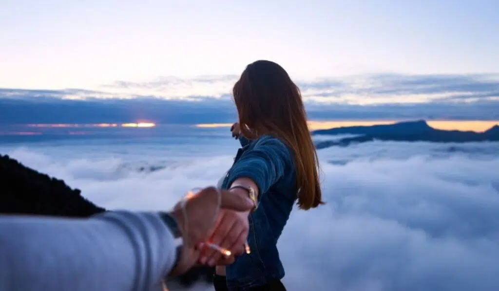 north node opposite chiron couple holdings hands in the clouds