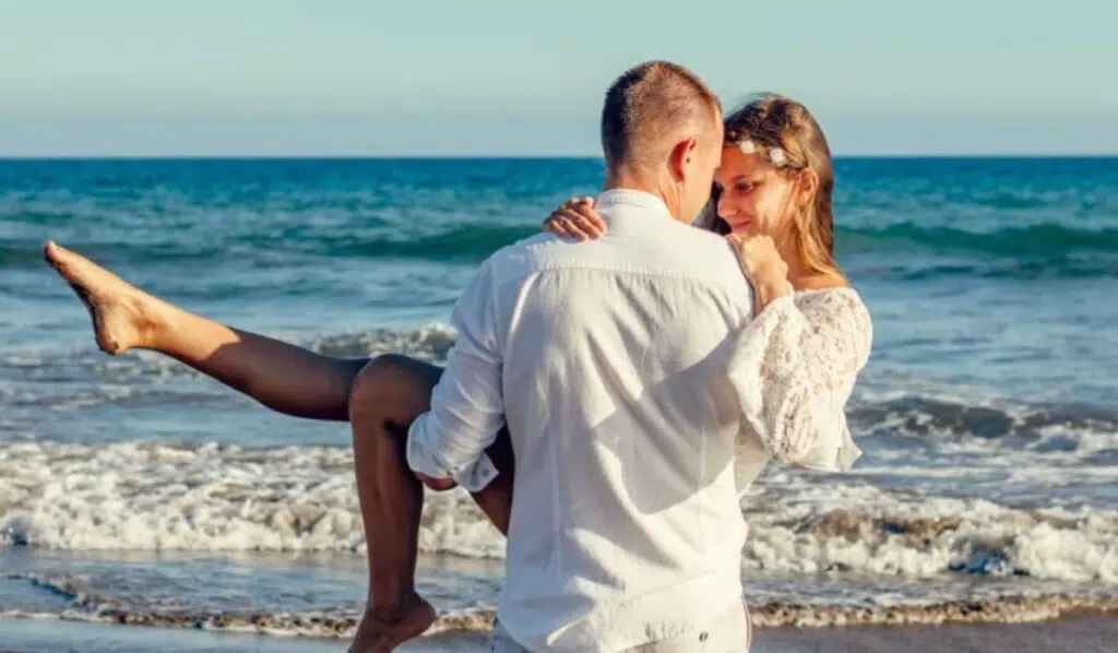 pluto square north node couple having fun on the beach