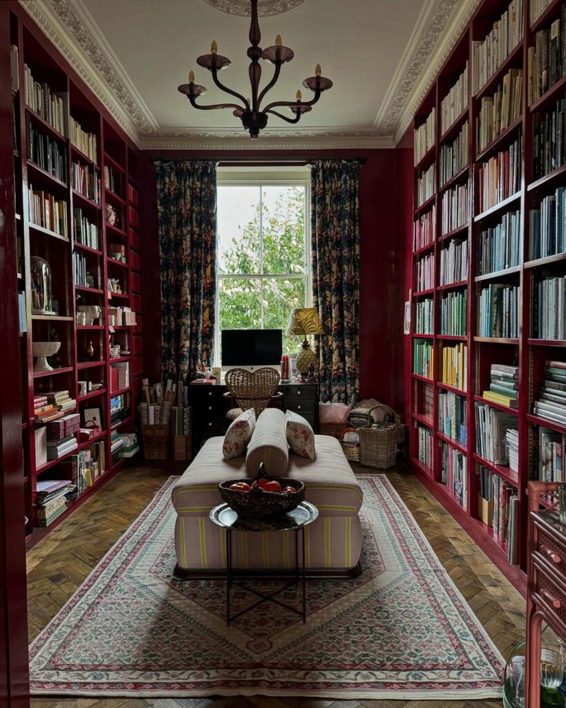 cozy-library-room-red-bookshelves-floral-curtains