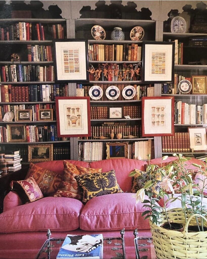 maximalist-library-living-room-pink-sofa-eclectic-shelves