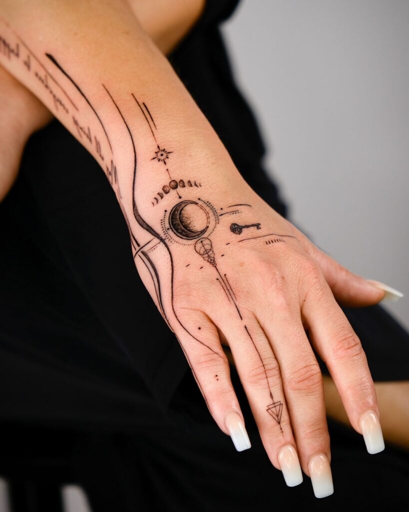 cosmic-key-moon-hand-tattoo