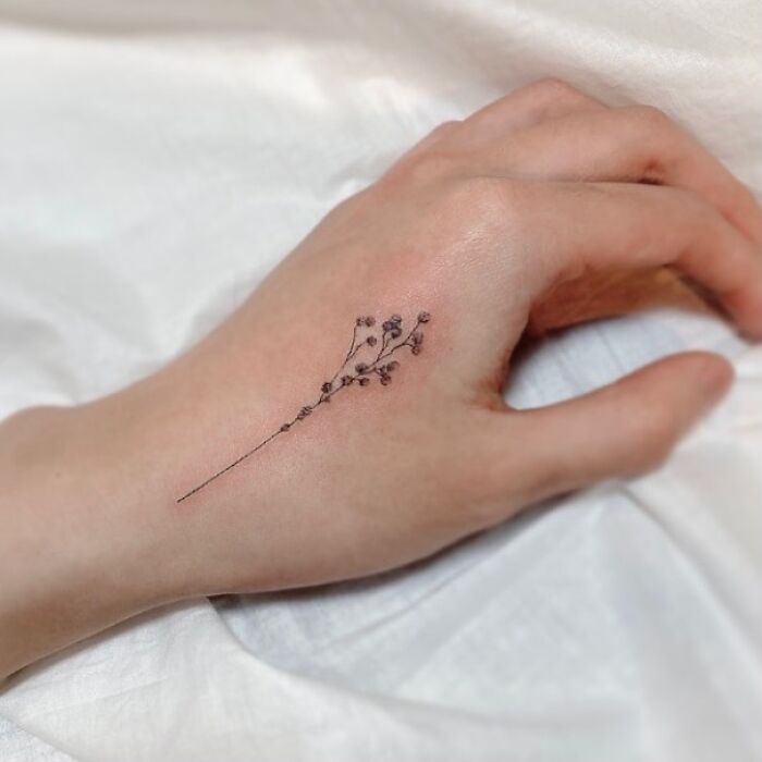 delicate-baby-breath-hand-tattoo