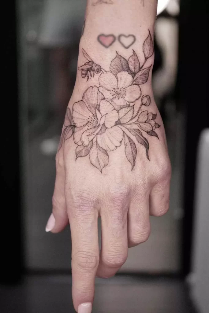 floral-and-bee-hand-tattoo