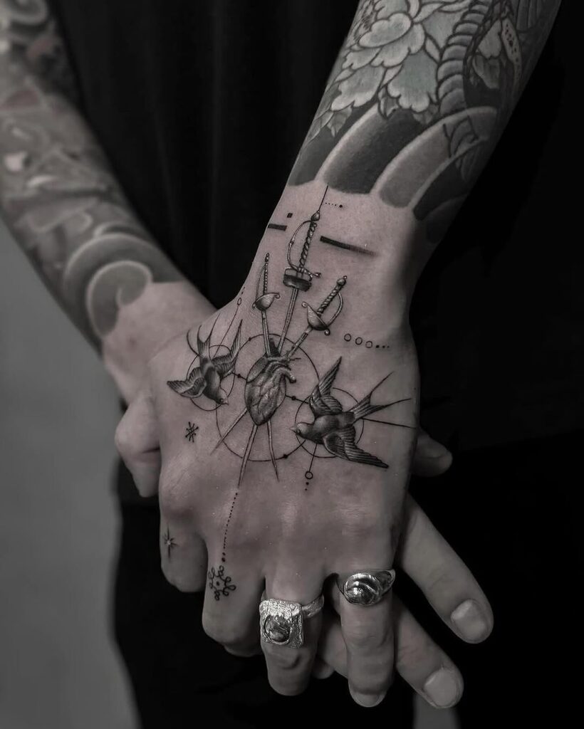 swords-hearts-doves-hand-tattoo