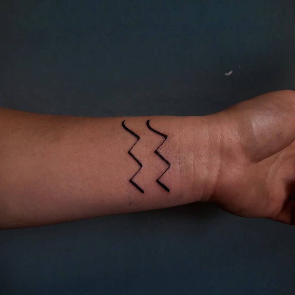 aquarius-minimal-wave-symbol-wrist-tattoo