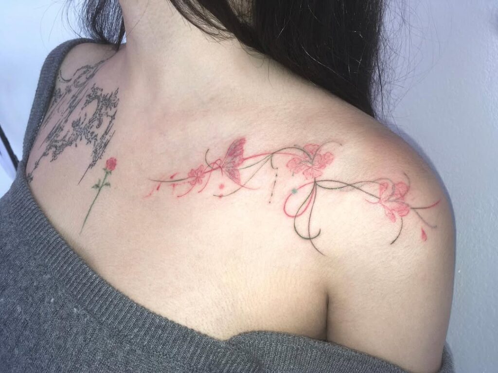 butterfly-and-pink-flower-collarbone-tattoo