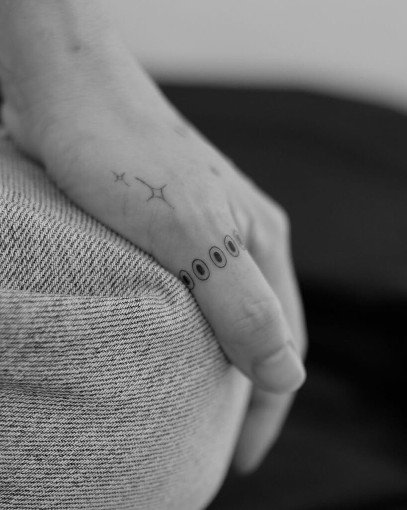 minimalist-line-ring-hand-tattoo-design