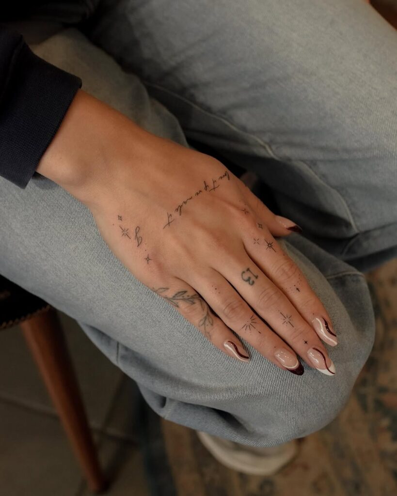 minimalist-script-and-symbol-hand-tattoo-design