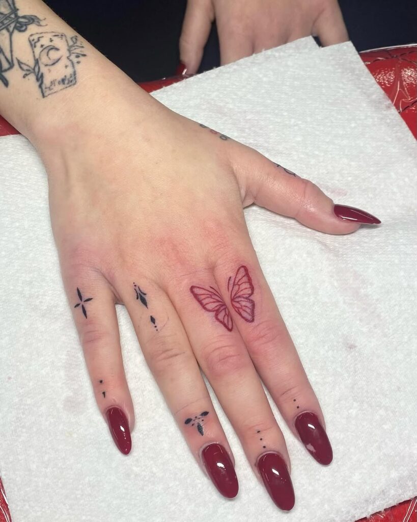 red-butterfly-and-symbol-finger-tattoo-design