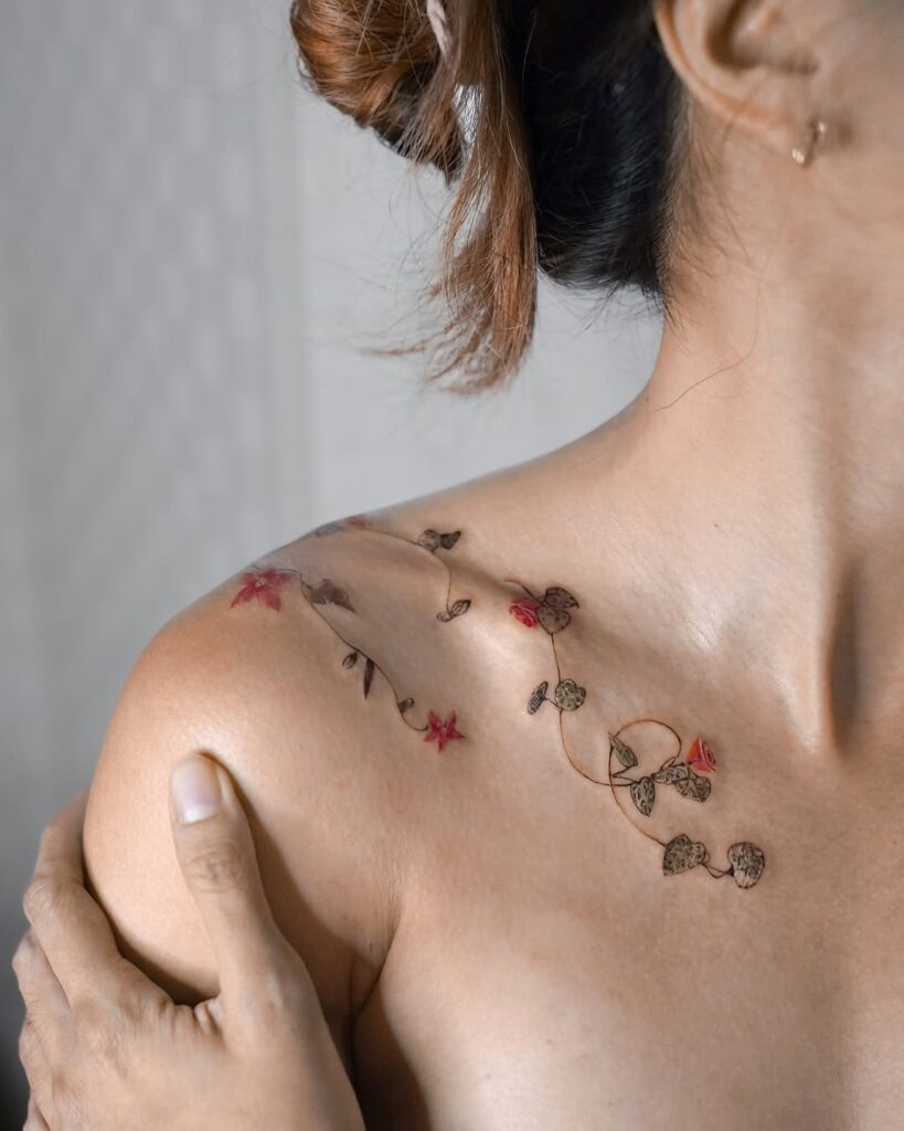 vine-and-red-floral-collarbone-tattoo