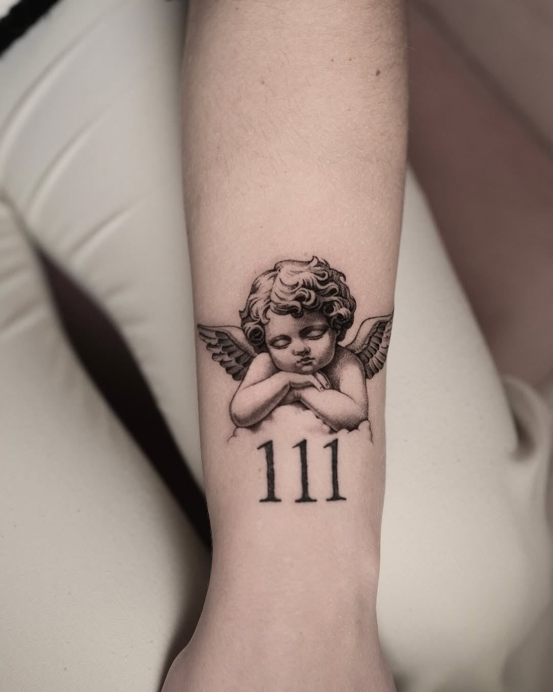 Cherubic angel tattoo with meaningful numbers