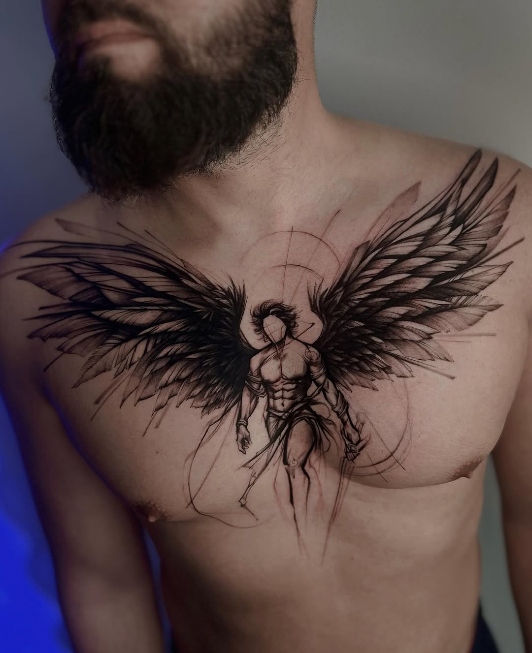 Muscular angel tattoos with striking wings.