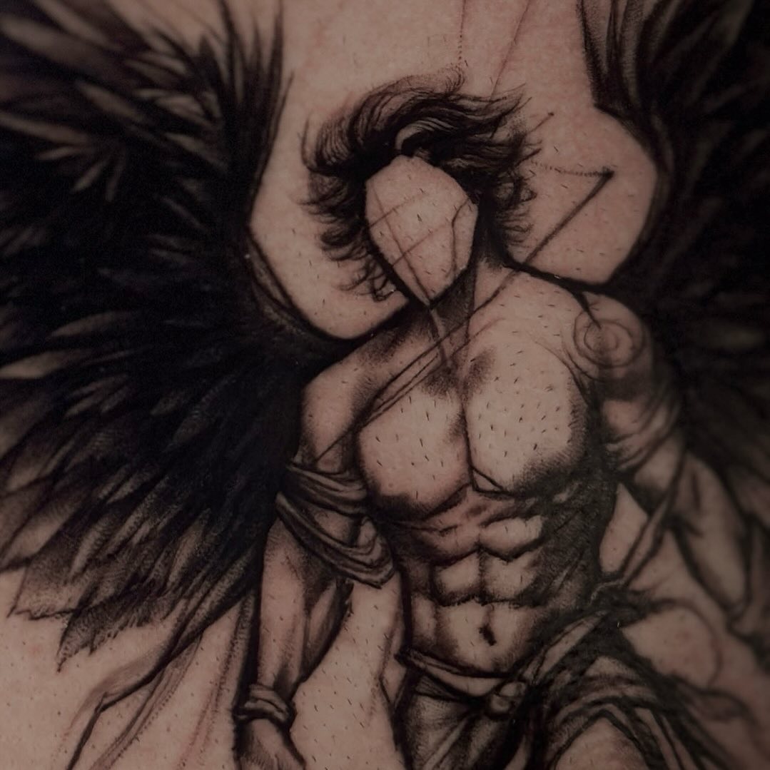 Dramatic angel tattoo embodying strength and power