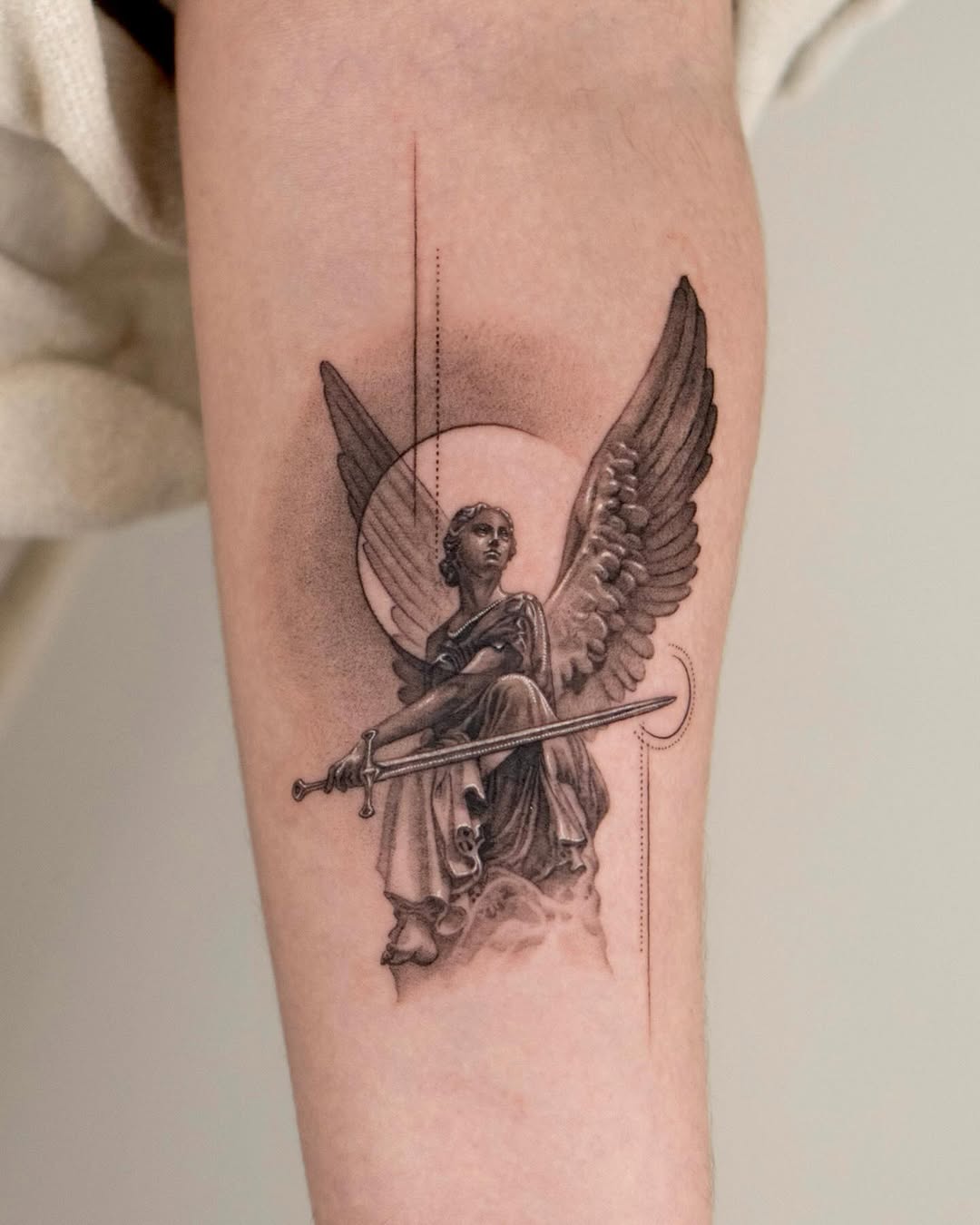 Majestic angel wielding a sword tattoo design