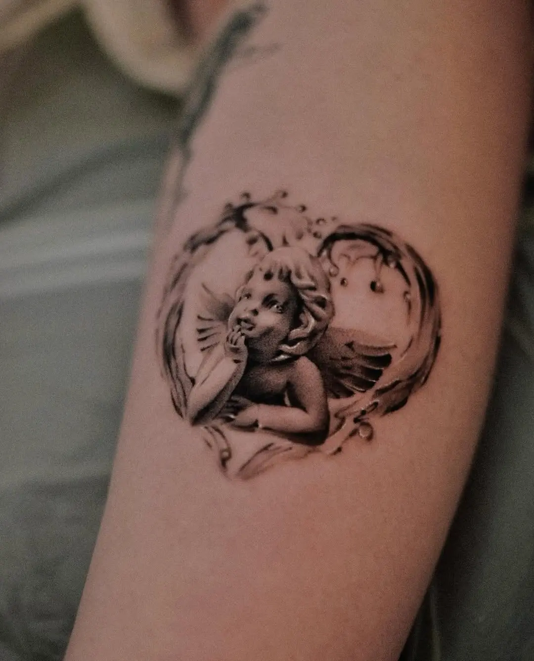 Vintage angel tattoo framed in ornamental heart