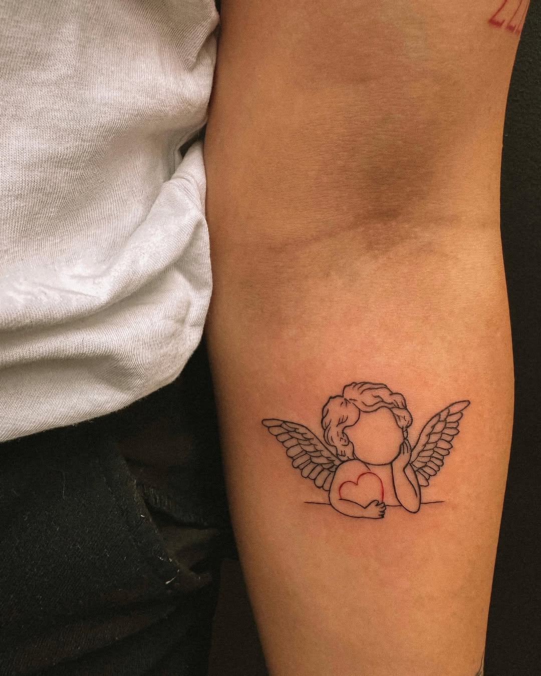 Charming angel tattoo with heart illustration