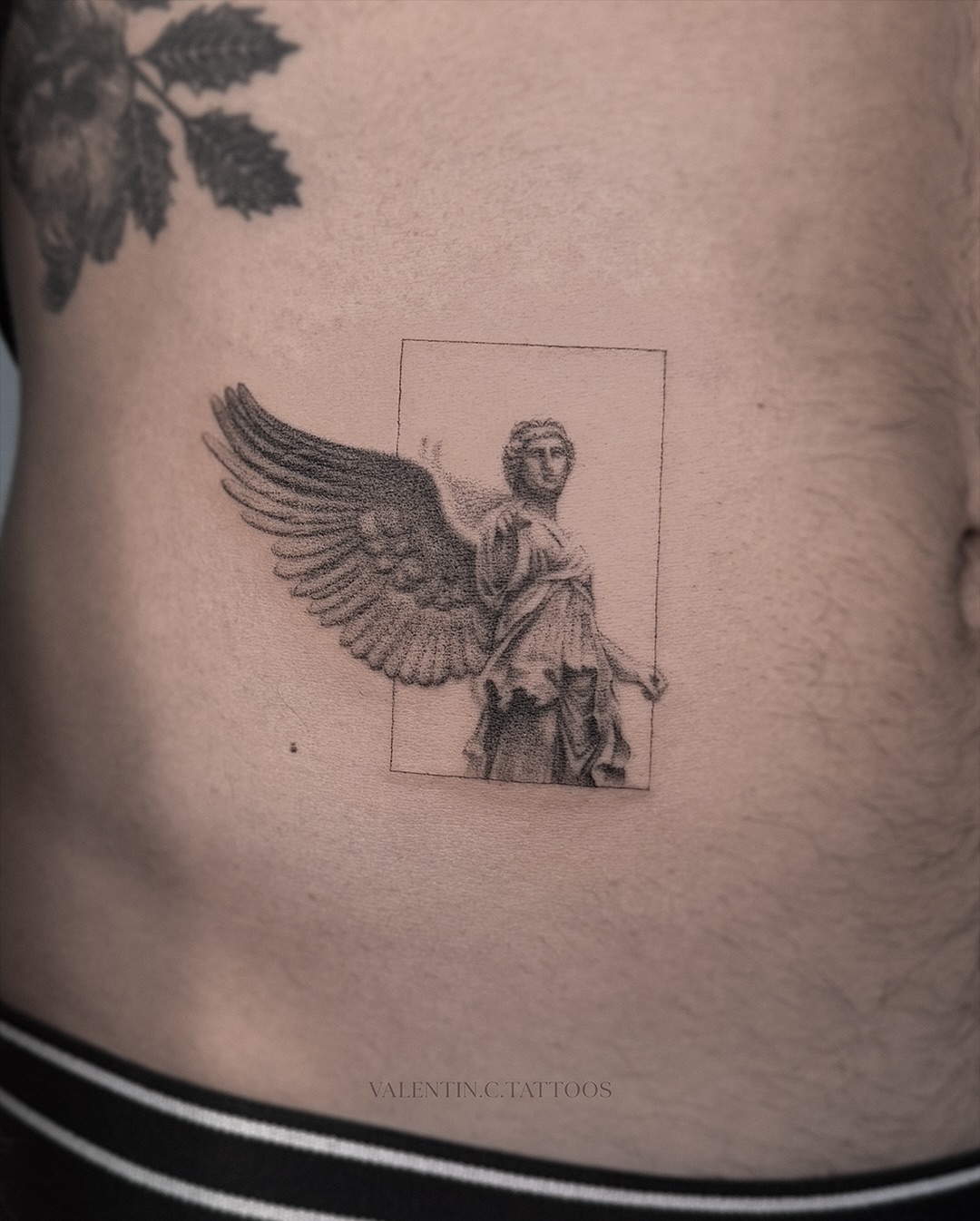 Elegant angel tattoo with a minimalist touch