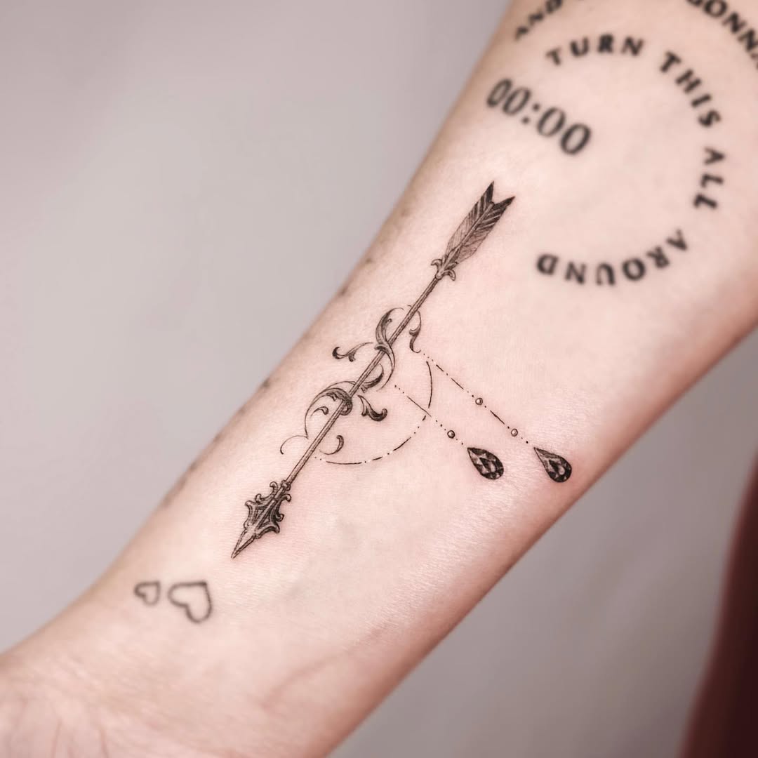 Elegant arrow tattoo with intricate details