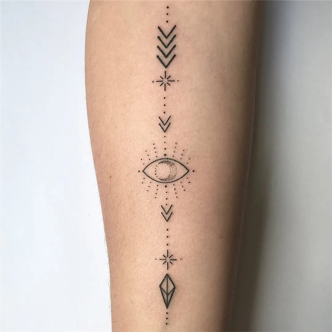 Geometric arrow tattoo with mystical eye design