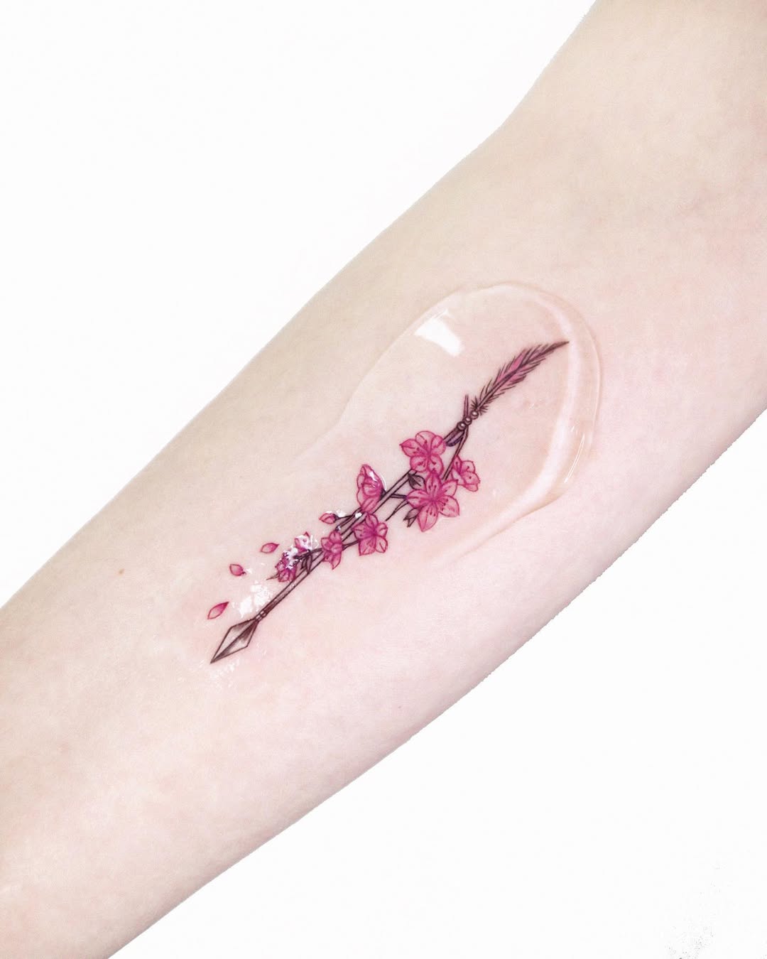 Delicate arrow intertwined with cherry blossoms