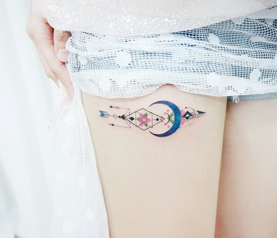 Elegant arrow tattoo with moon and geometric shapes