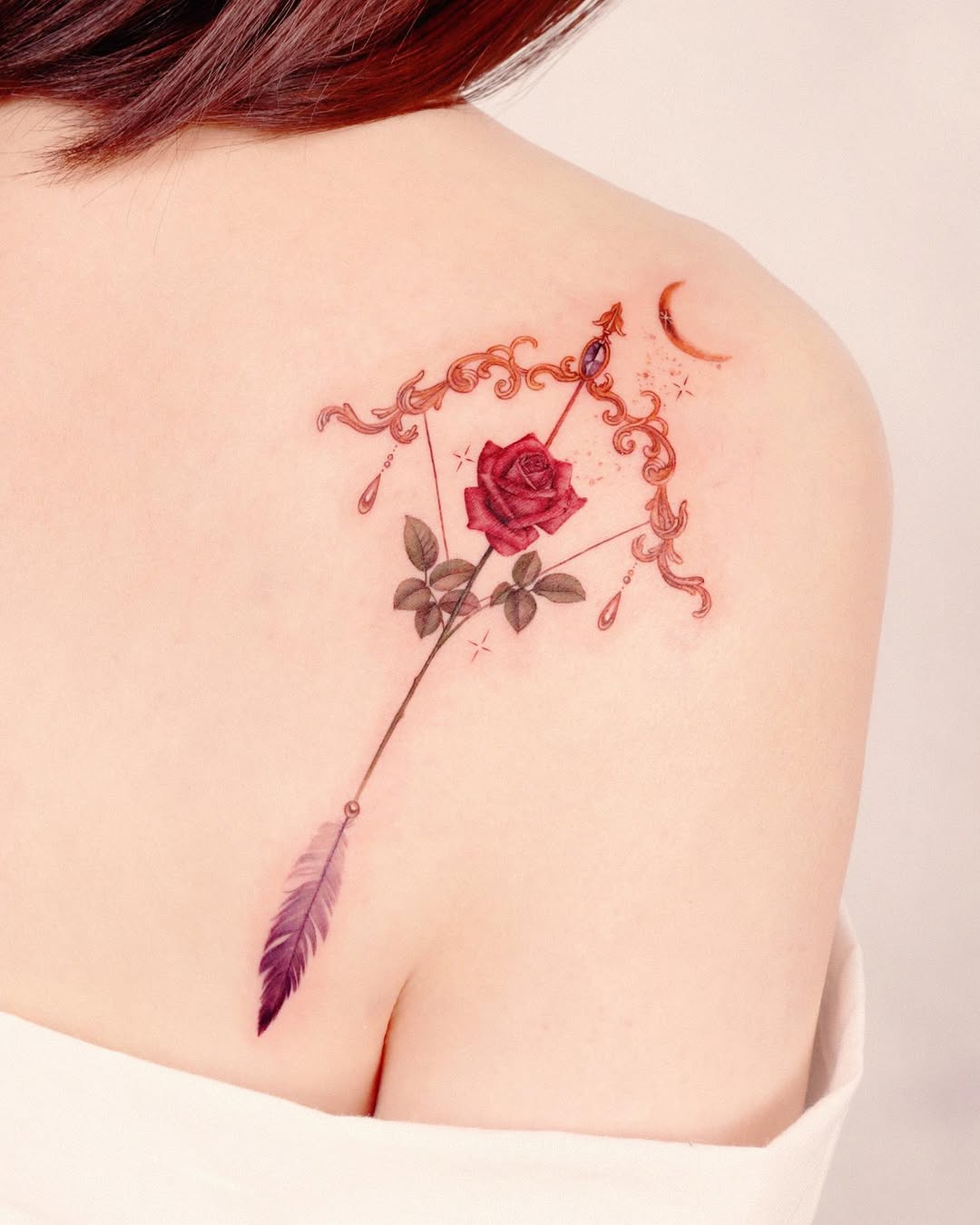 Elegant arrow tattoo with floral accents