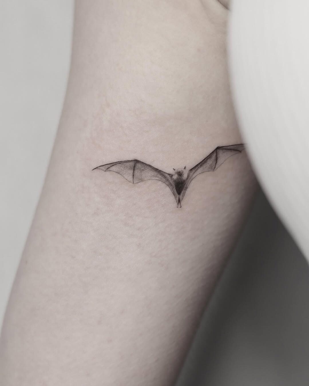 Elegant bat tattoo adds dark aesthetic touch