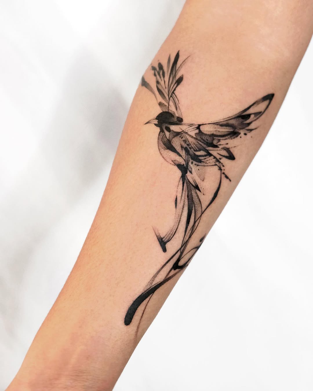 Elegant bird tattoo in mid-flight