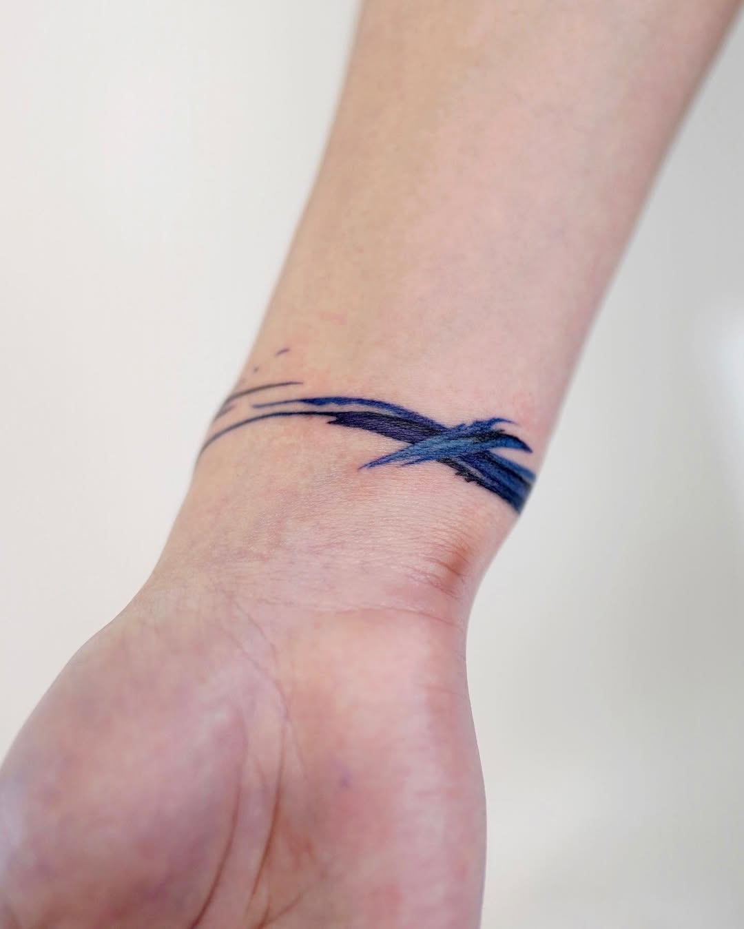 Elegant blue wave bracelet tattoo design