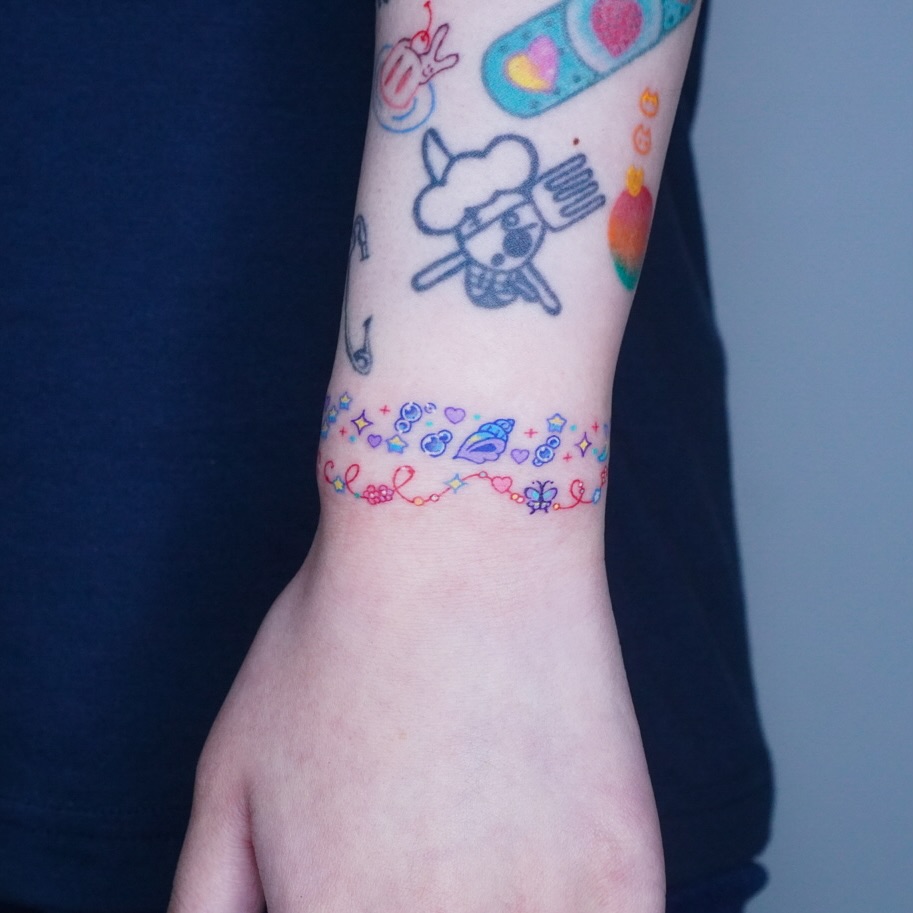 Vibrant Bracelet Tattoo with Playful Details