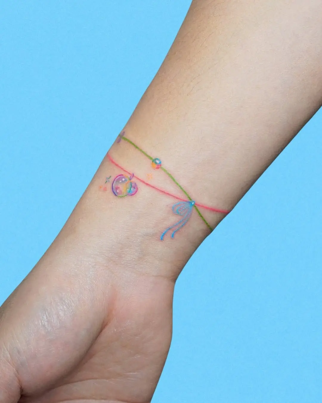 Colorful bracelet tattoo with playful elements