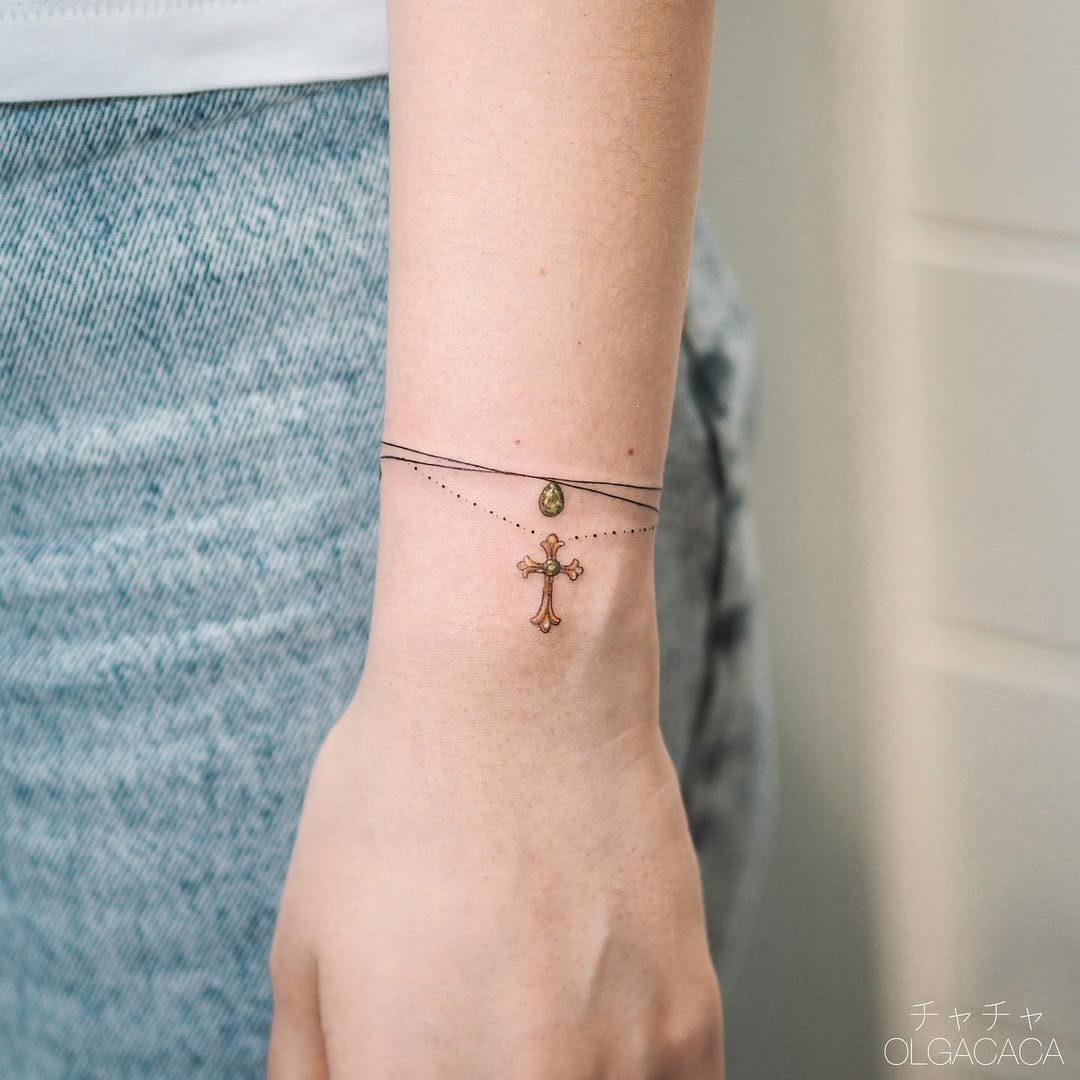 Elegant cross bracelet tattoo with decorative chains