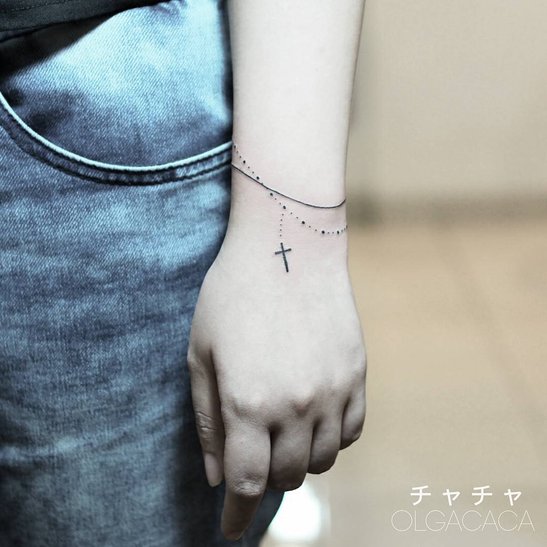 Elegant bracelet tattoo with a cross design