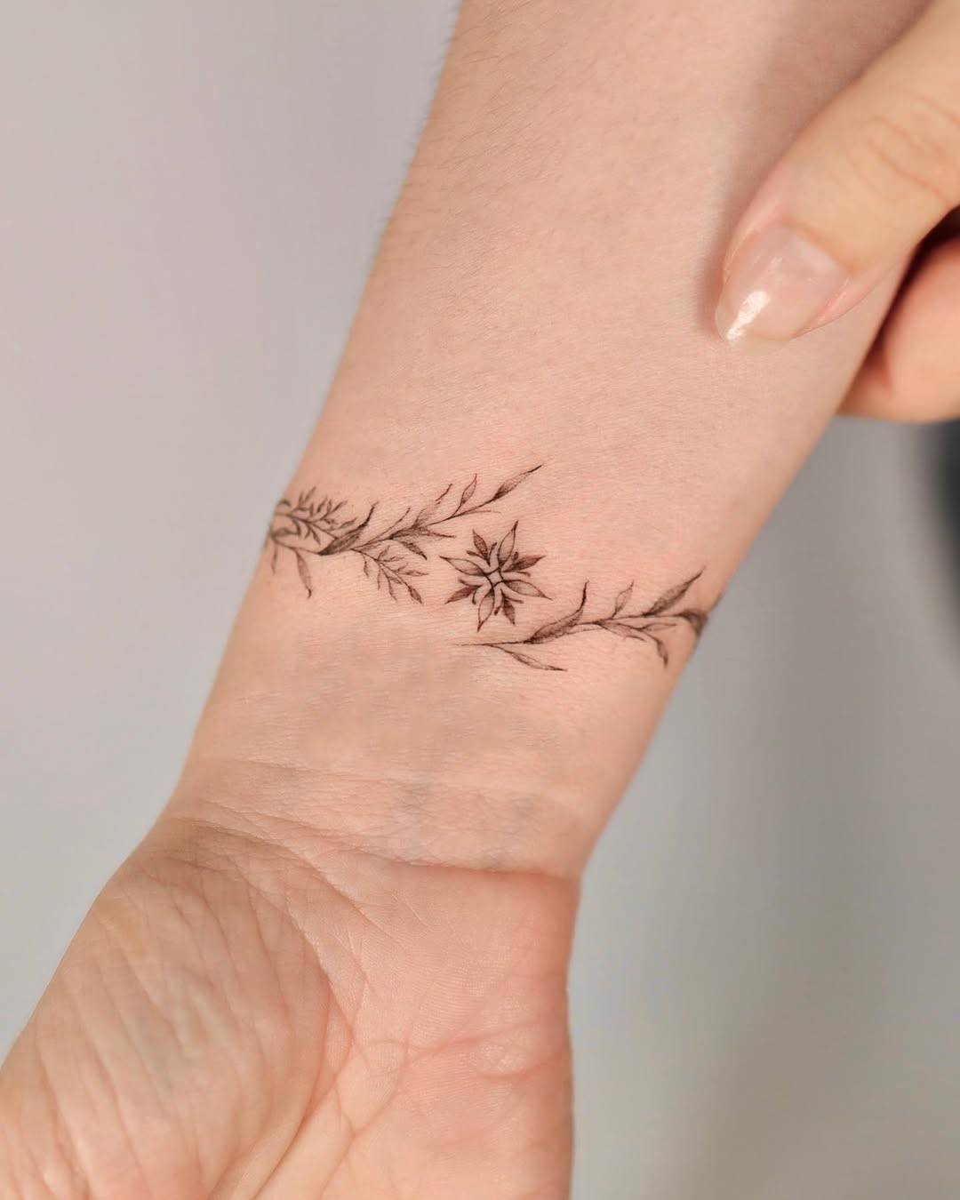 Elegant floral bracelet tattoo on the wrist