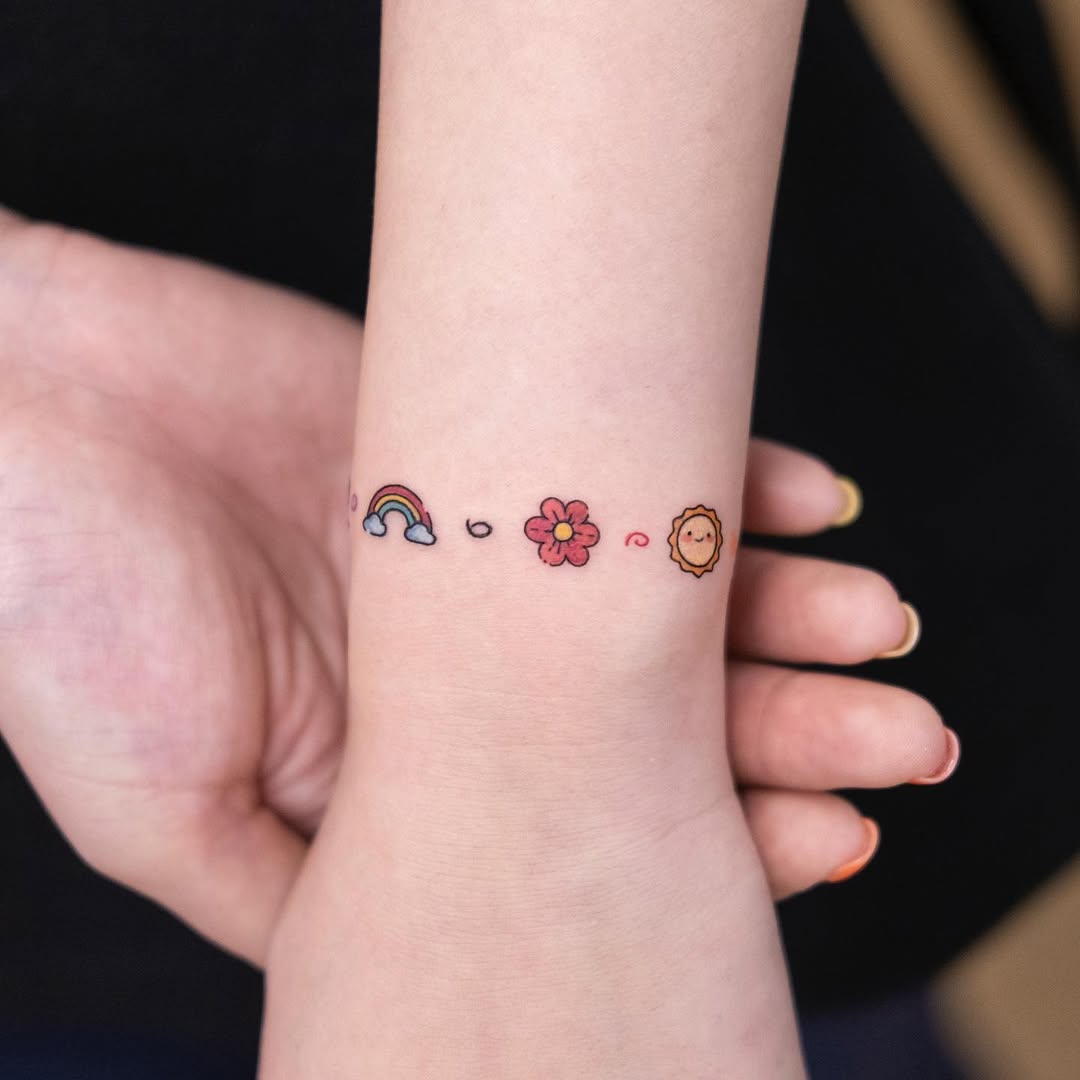 Colorful bracelet tattoo with nature-inspired symbols