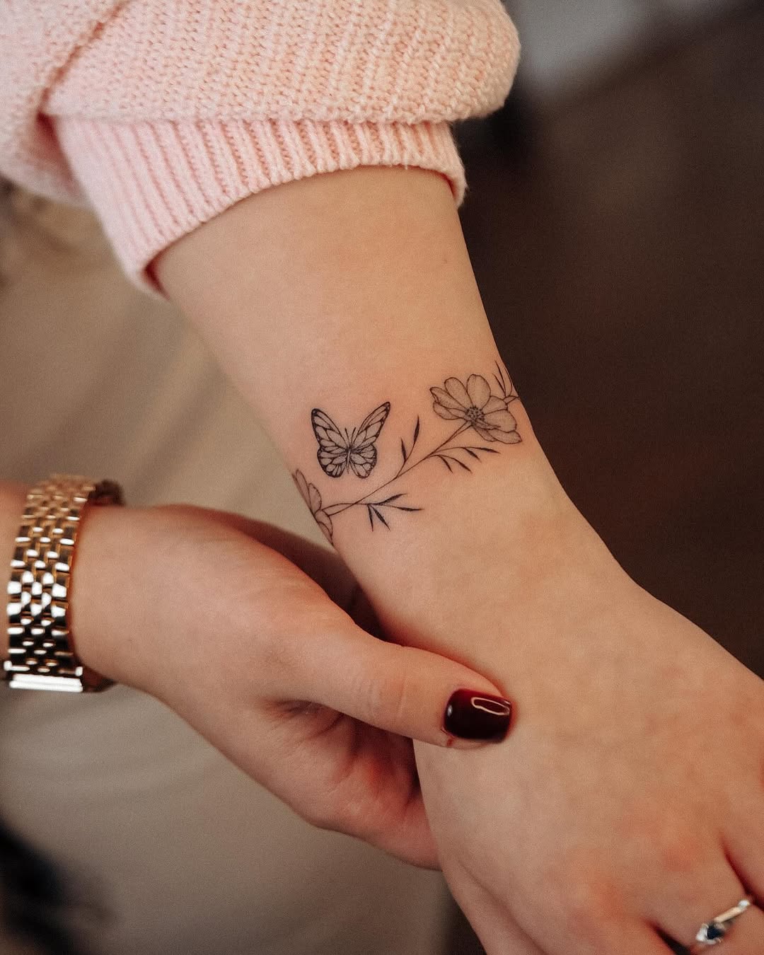 Delicate butterfly and floral bracelet tattoo design