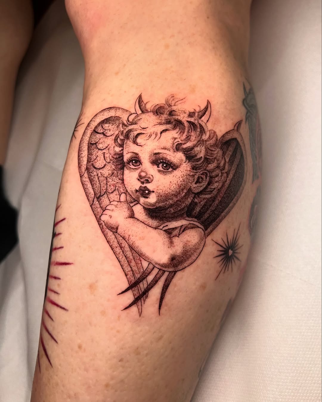 Charming cherub angel with heart wings tattoo