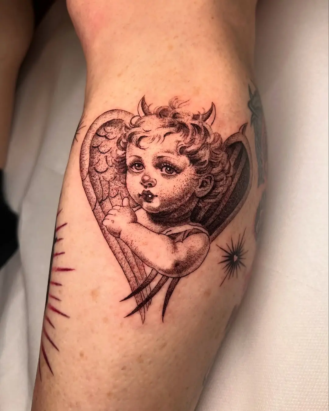 Charming cherub angel with heart wings tattoo