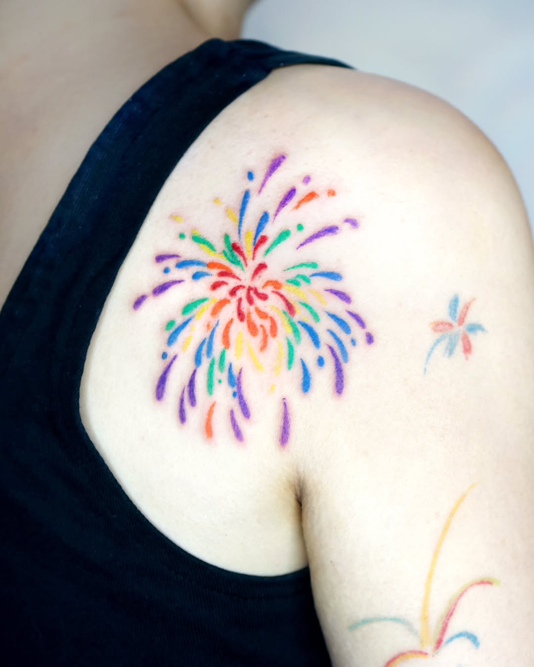 Vibrant Rainbow Explosion Tattoo on Shoulder