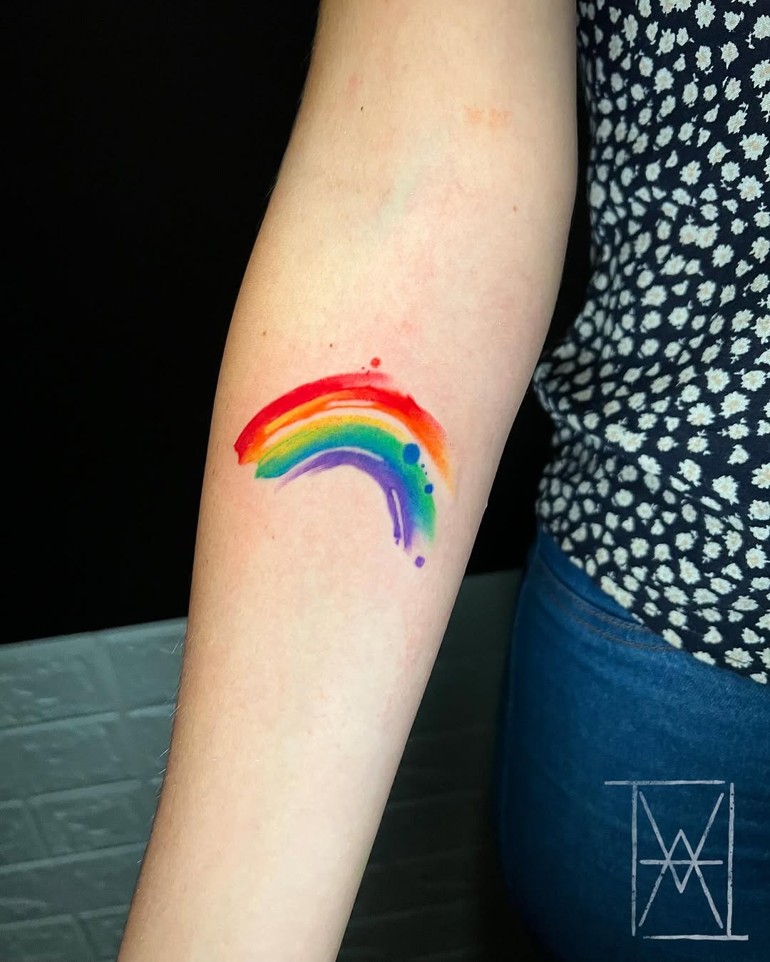 Vibrant Rainbow Tattoo on a Person's Arm