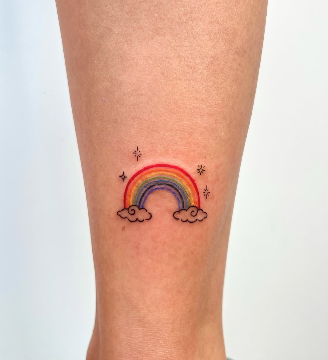 Charming Rainbow Tattoo with Cloud Elements