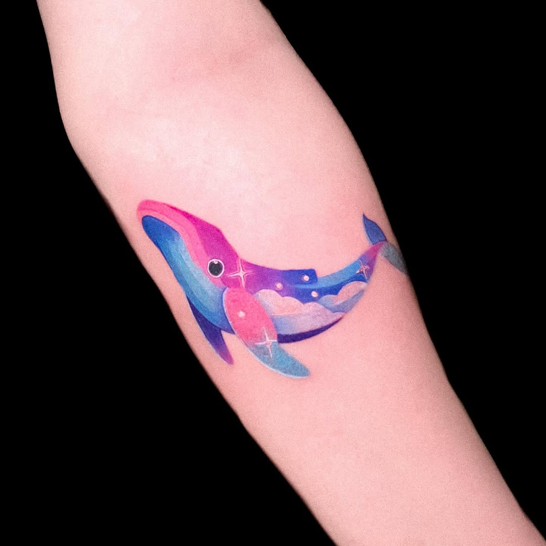 Vibrant whale tattoo with cosmic elements