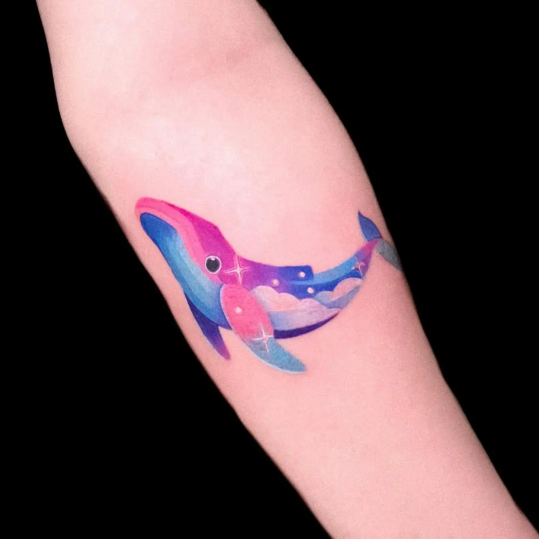 Vibrant whale tattoo with cosmic elements