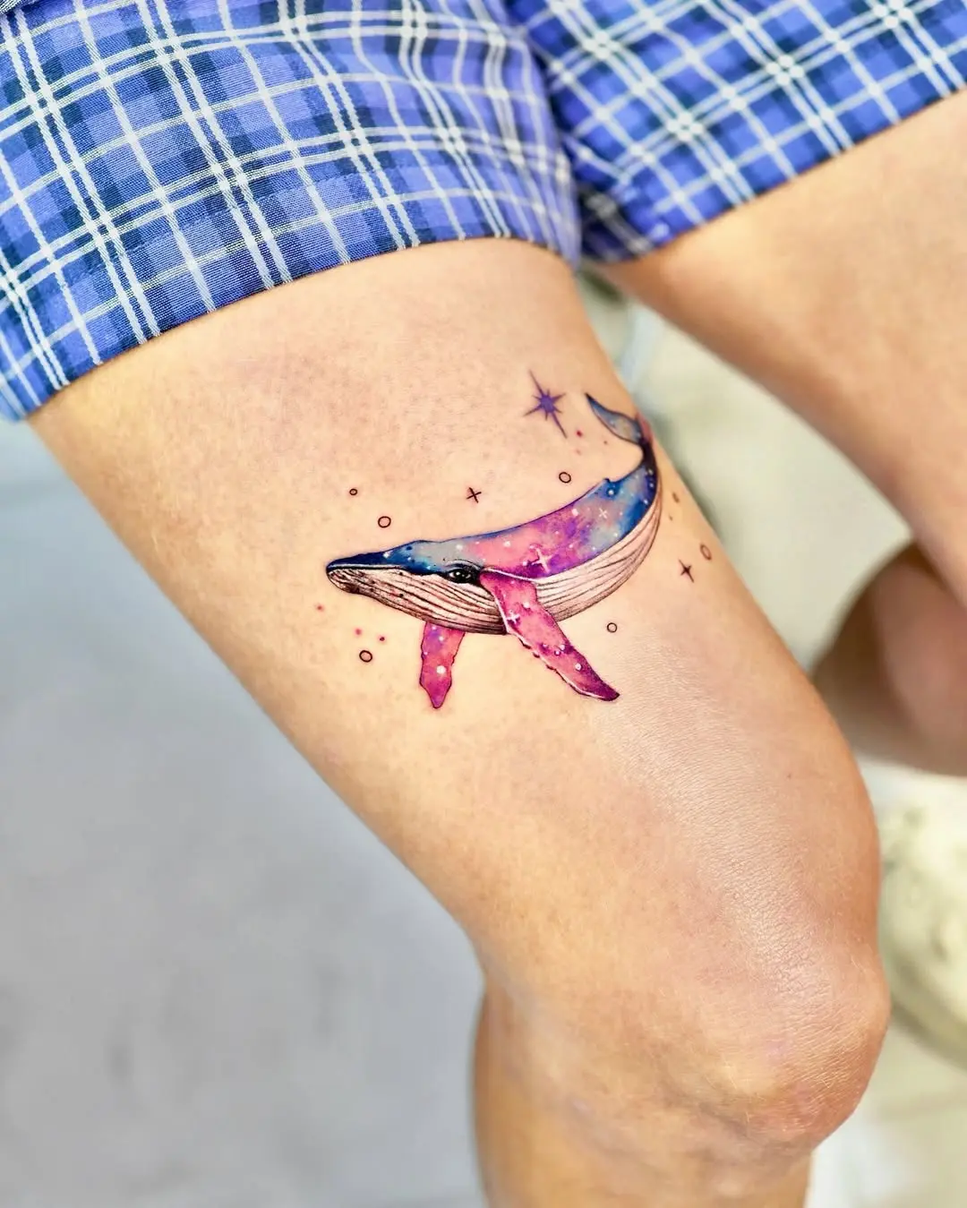 Vibrant whale tattoo with galaxy elements