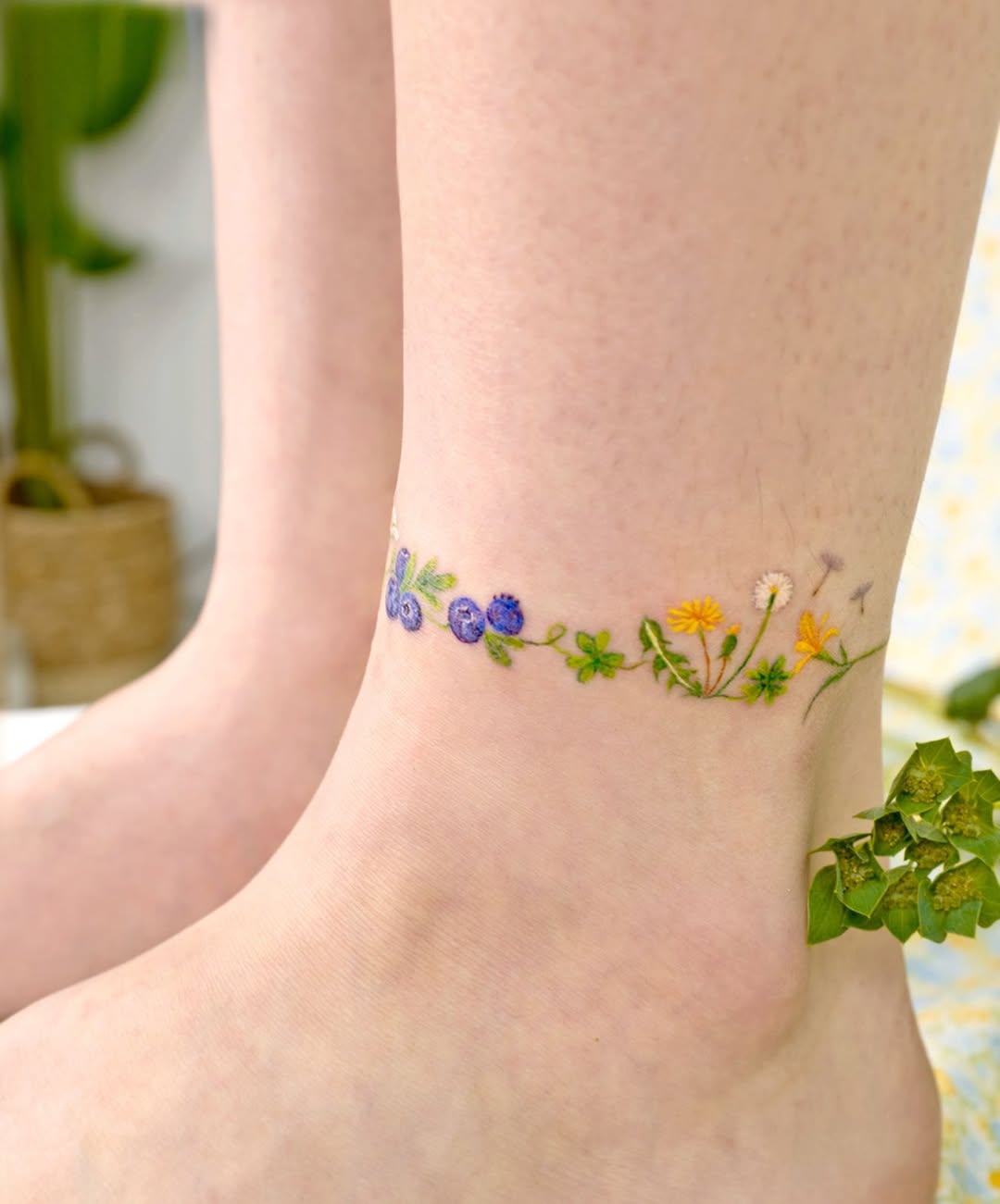 Whimsical ankle tattoo featuring colorful wildflowers